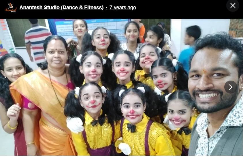 Kids ensemble in clown costumes backstage