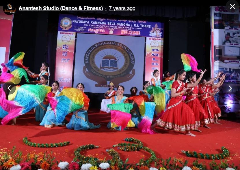 Colourful fan dance performance on stage