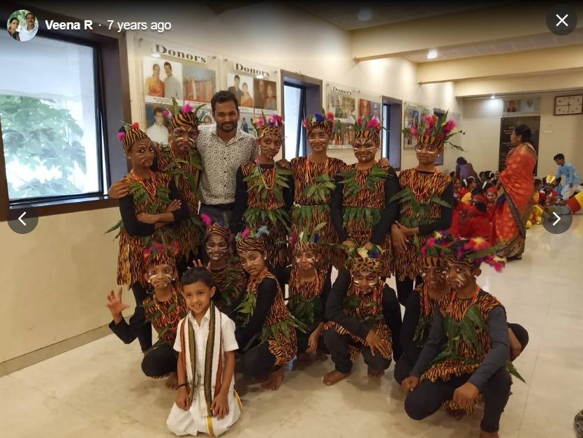 Tribal-costume dance group posing with instructor