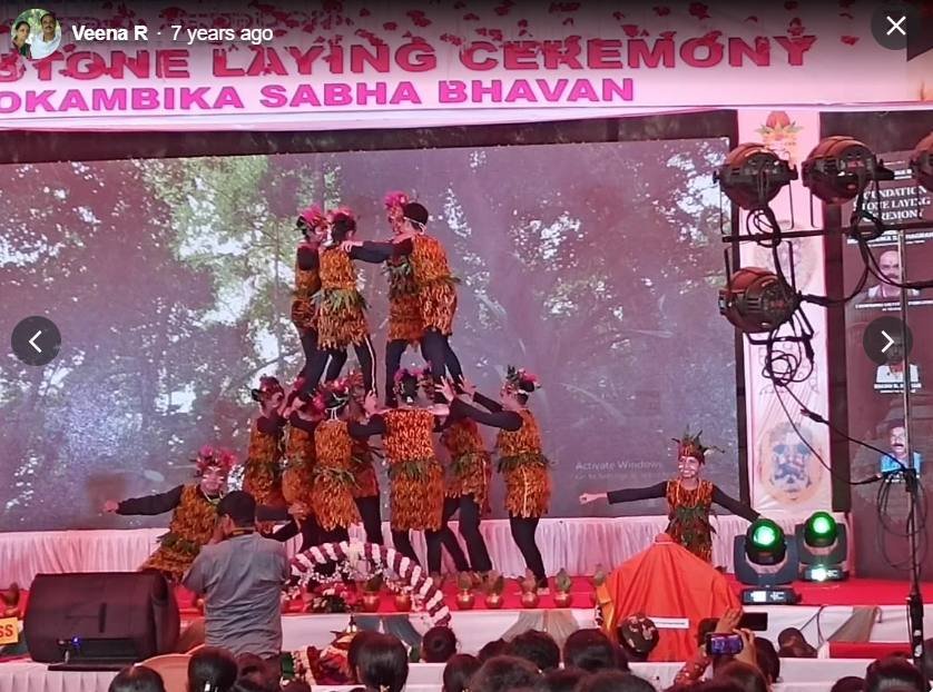 Human pyramid formation in tribal costume on stage